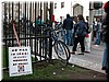 A poster by 'Labor Against War' aptly rests on a jail-like fence.
