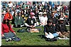 Dozens of protesters meditate even while the speakers blare off anti-war speeches.