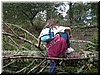 Tracy climbs over a fallen tree on the trail.  No problem!